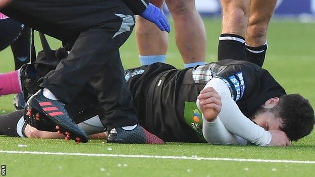 Alex Dunbar writhes in agony after suffering a leg injury