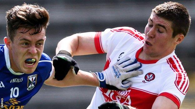 Cavan's Dara McVeety attempts to hold off Ciarán McFaul of Derry