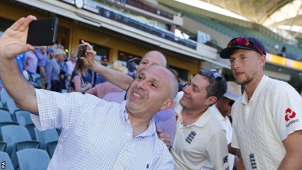 Joe Root poses for photos with fans after England's defeat in the first Test in Brisbane