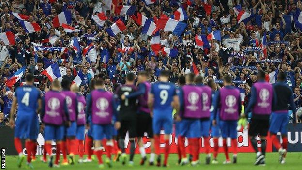 The France players at the end of the game, with a backdrop of French fans