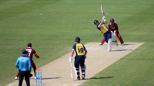 Warwickshire's Sam Hain goes aerial against the West Indies in the Persian Gulf