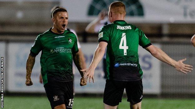 Jonathan Evans (left) celebrates his goal against Flint Town United