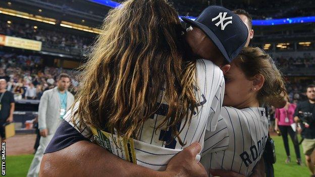 Alex Rodriguez hugs his daughters Natasha and Ella