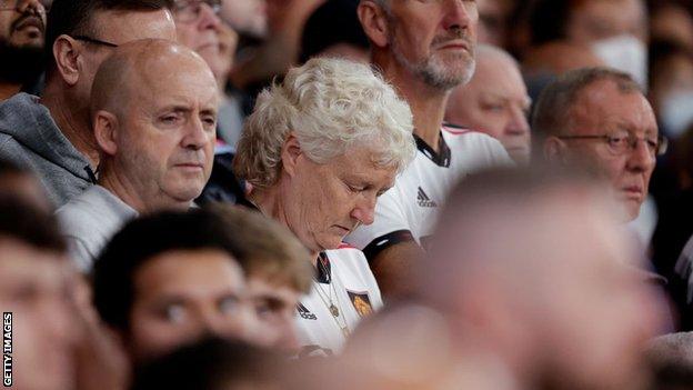 Fans observe a minute's silence