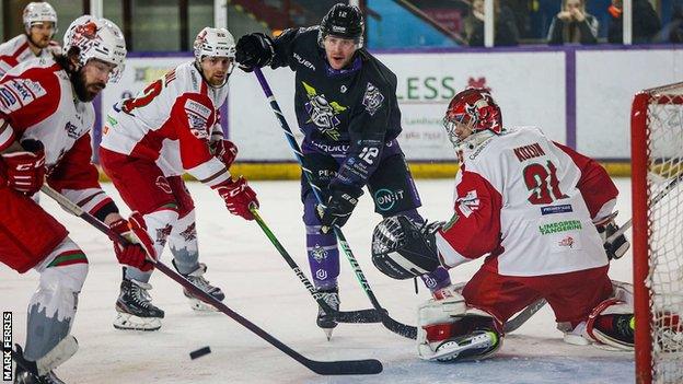 Josh Batch clears the puck after Taran Kozun makes the save