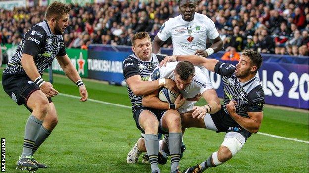 Dan Biggar and Rhys Webb of Ospreys hold up Paul Jedrasiak who made his debut for France in 2016