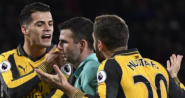 Arsenal's Granit Xhaka and Shkodran Mustafi remonstrate with referee Michael Oliver as he awards a penalty to Bournemouth in the Gunners' 3-3 draw on 3 January