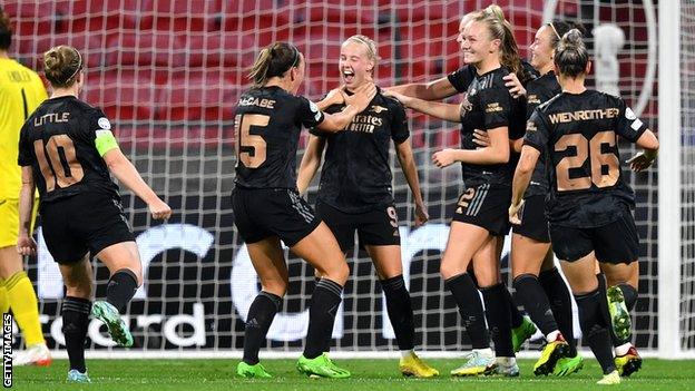 Arsenal celebrate their fifth goal against Lyon