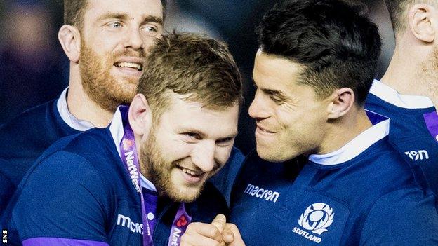 Finn Russell and Sean Maitland celebrate Scotland's win over England