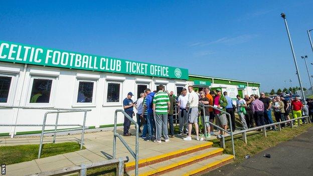 Celtic fans queue outside the ticket office