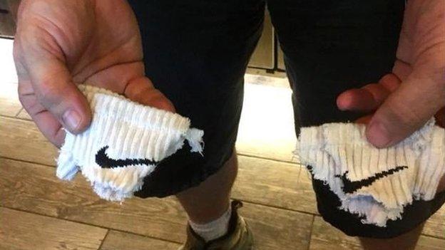 A picture of a pair of destroyed Nike socks.