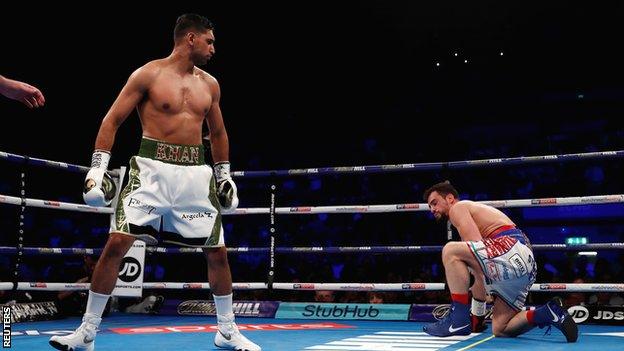 Amir Khan looks at the kneeling Phil lo Greco