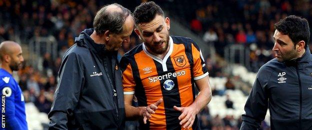 Robert Snodgrass goes off injured for Hull against Stoke City