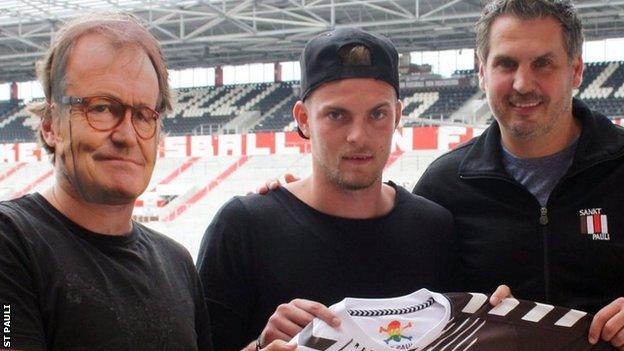 A masked man pretends to be Ewald Lienen as St Pauli parade new striker Marvin Ducksch.