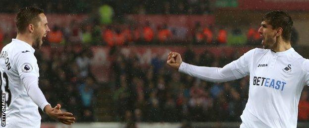 Gylfi Sigurdsson and Fernando Llorente celebrate at Swansea