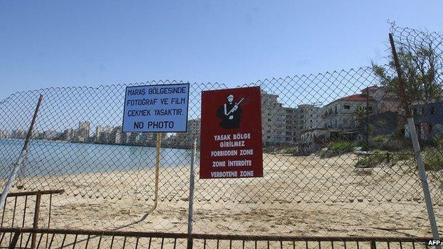 signs forbidding entry and photographs on fence