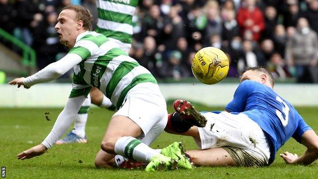 Celtic's Leigh Griffiths tumbles in the box after a challenge from Rangers' Clint Hill