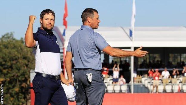 Ryan Moore and Lee Westwood on the 18th green