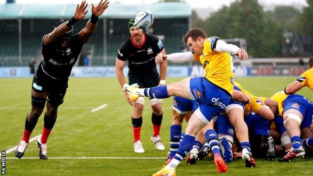 Ben Spencer launches a clearing kick for Bath against Saracens