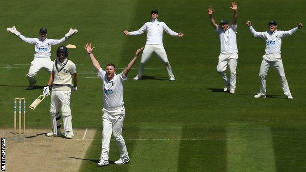 Ollie Robinson (third from left) appeals for a wicket at Hove
