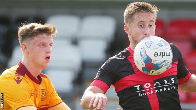 Jordan Armstrong in action against Michael Carvill of Crusaders