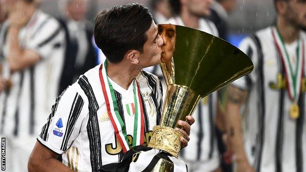 Juventus striker Paulo Dybala kisses the Serie A trophy after winning it in 2019-20