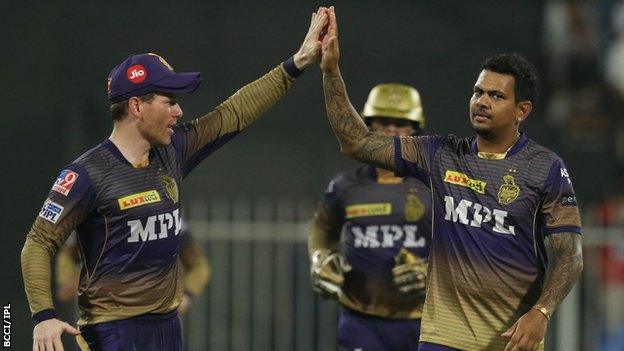 Kolkata Knight Riders captain Eoin Morgan (left) and Sunil Narine (right) high five after Narine takes a wicket against Royal Challengers Bangalore