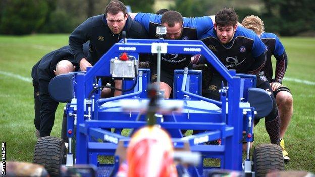 Daniel Ricciardo pits an F1 car against the Bath rugby scrum