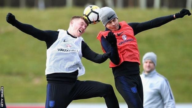 Alfie Mawson duels for a header with Dele Alli