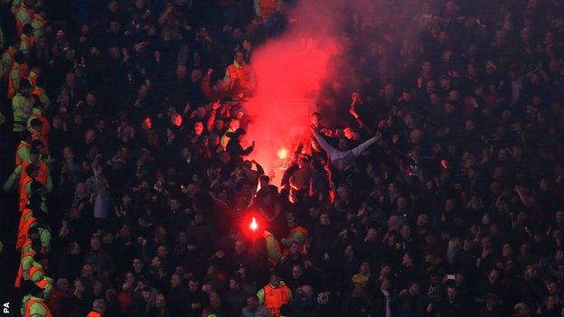 Liverpool fans light flare