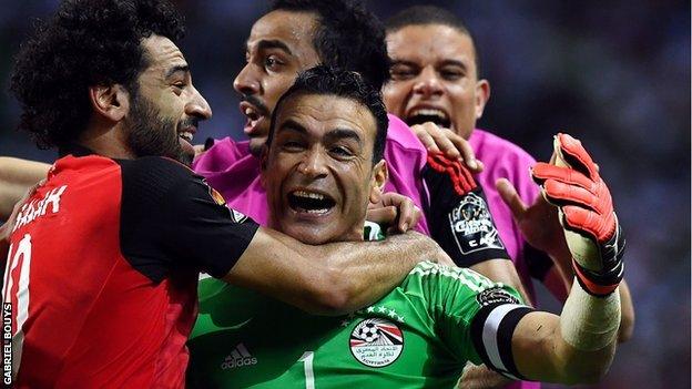 Essam El Hadary is mobbed by his team-mates after the penalty shootout win over Burkina Faso