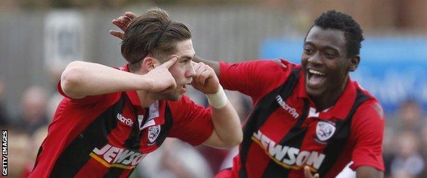 Joe Tumelty (left) celebrates the Bulls' late winner at the Ray Mac Stadium with team-mate Mustapha Bundu