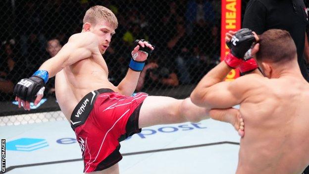 Arnold Allen pictured kicking Calvin Kattar