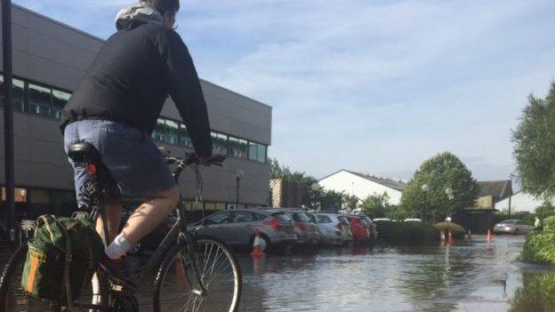 Cyclist in flooded car park