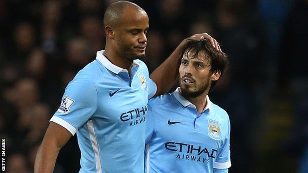 Vincent Kompany is consoled by team-mate David Silva