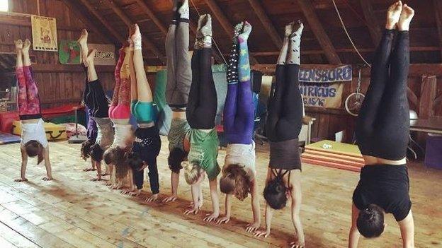 line of people doing handstands