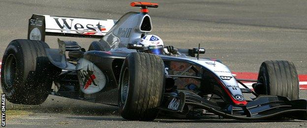 McLaren's David Coulthard spins off a track as the front left tyre is punctured during the Chinese Grand Prix in Shanghai, 26 September 2004