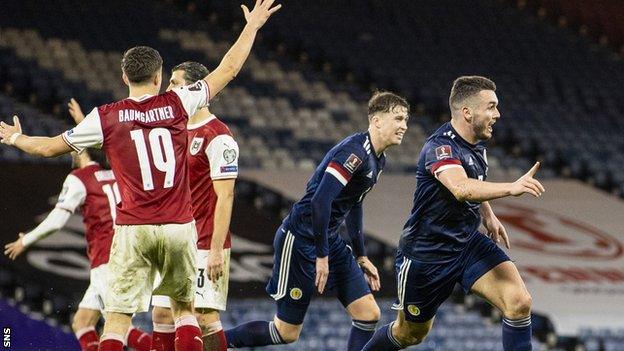 John McGinn (right) celebrates after equalising for Scotland five minutes from time