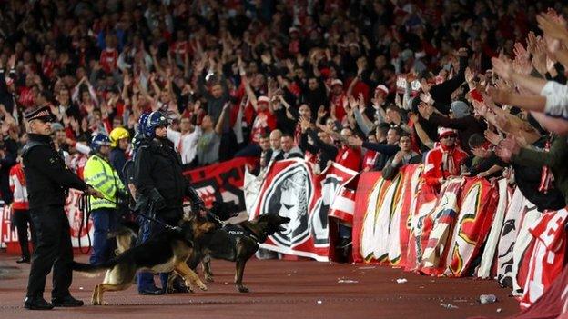 Police in front of away fans at the Emirates Stadium