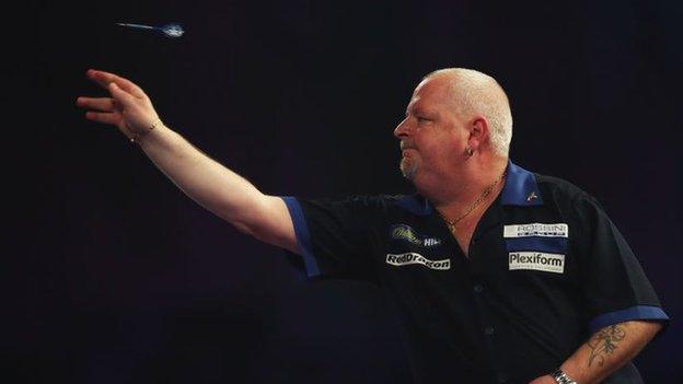 Darts player Robert Thornton in action