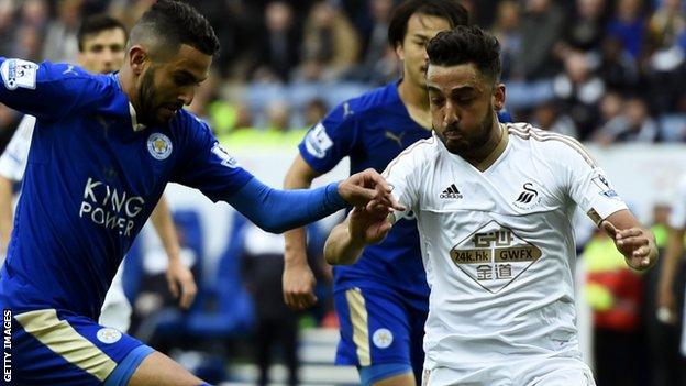 Riyad Mahrez of Leicester City takes on Swansea City's Neil Taylor