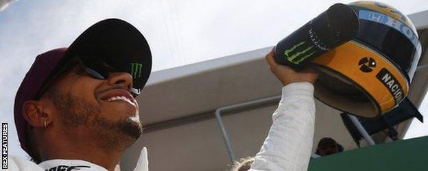 Lewis Hamilton with the helmet gifted to him by the family of Ayrton Senna