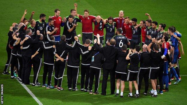 The Welsh team gather after the final whistle for one last huddle