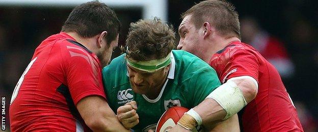 Wales' Aaron Jarvis and Gethin Jenkins tackle Ireland number eight Jamie Heaslip