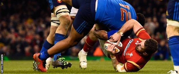 Alex Cuthbert of Wales is tip tackled by Jonathan Danty