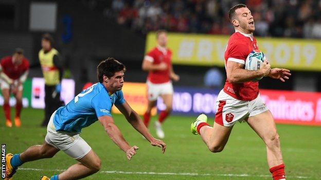 Wales replacement Gareth Davies runs past Uruguay's centre Tomas Inciarte to score a try