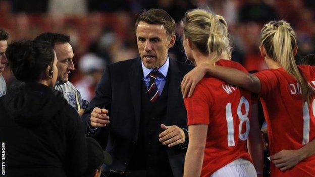 Phil Neville speaks with his England players