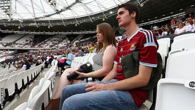 A West Ham fan watches a rugby match between the Barbarians and Samoa