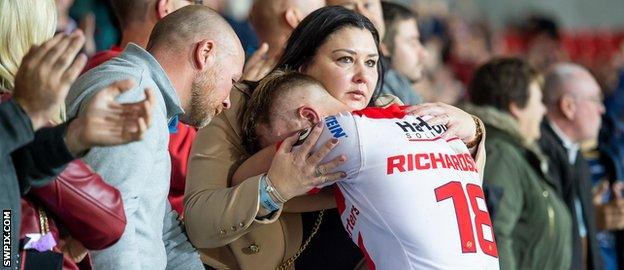 Danny Richardson consoled by his family after Saints lost their play-off game against Warrington
