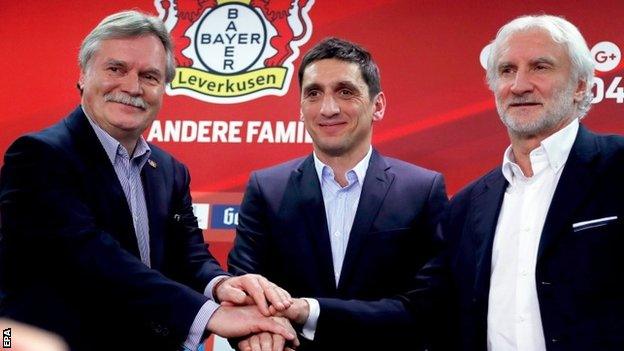 Bayer Leverkusen's new head coach Tayfun Korkut poses for photographers with chief executive Michael Schade and sports director Rudi Voller